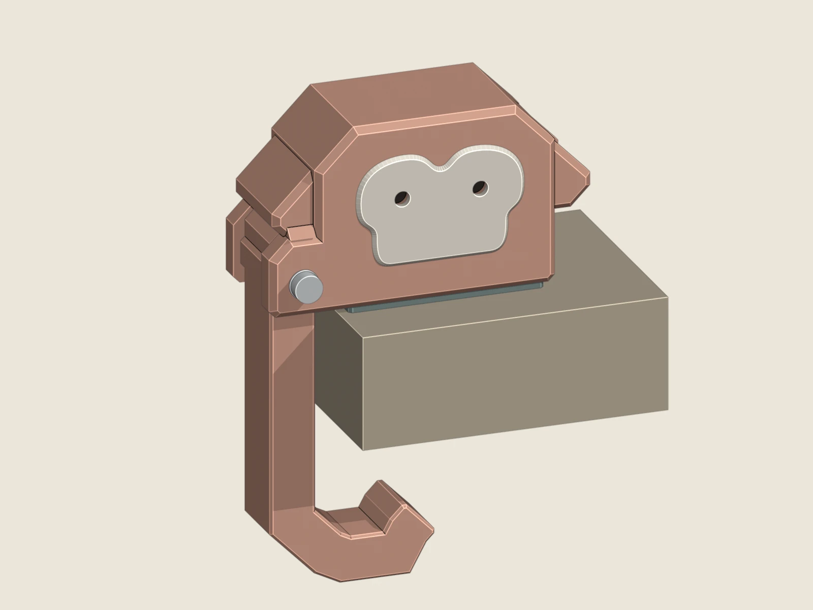 The v0.3 monkey hook assembled on a desk, with a terracotta head and hook, cream face and dark recessed eyes.